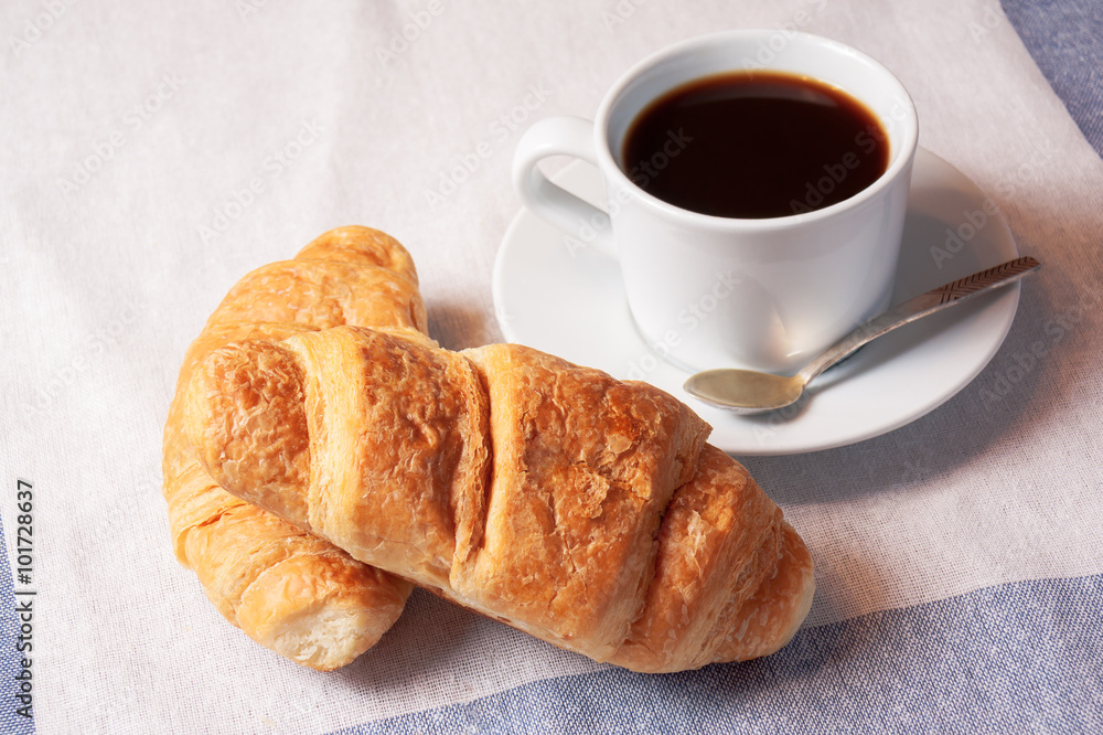 Breakfast with cup of black coffee and  croissants