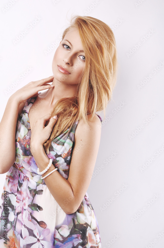 Fototapeta premium portrait of the young beautiful woman in a color dress. Lies. white background. 