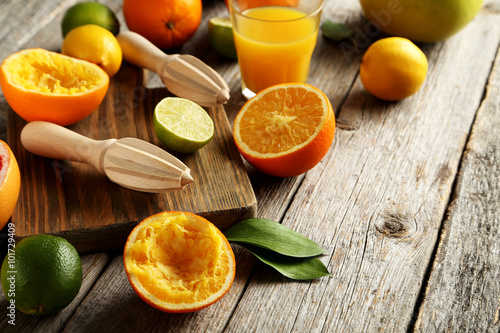 Wooden juicer and orange on a wooden table