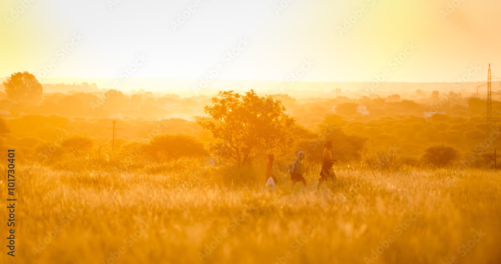 African Family Walking At Sunset
