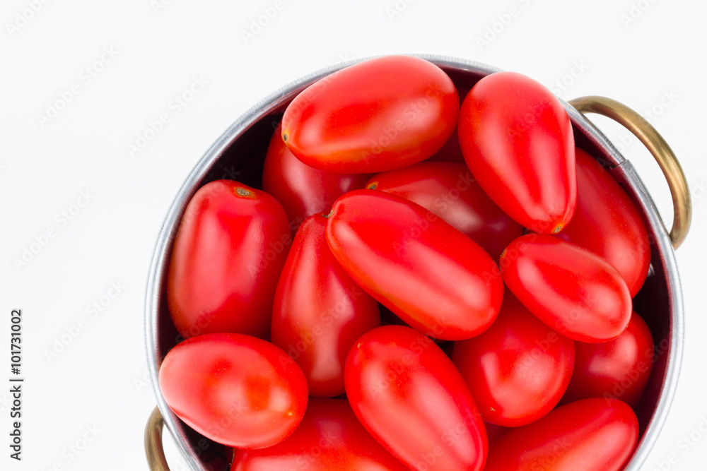 Ripe red grape tomatoes in metal strainer Ripe red grape tomatoes in metal strainer