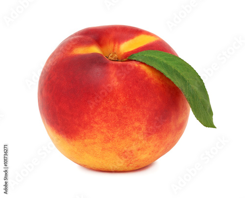 One whole ripe nectarine with green leaf (isolated)