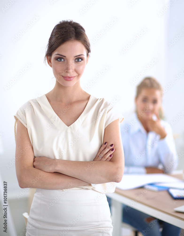 Attractive businesswoman standing near wall in office Attractive businesswoman standing near wall in office