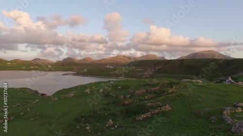 Stunning aerial shot on the Isle of Harris, Scotland, flying along the coastline at Uig during sunset
 photo