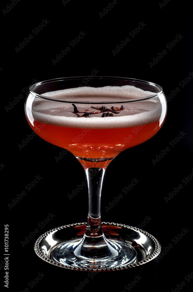 red cocktail with foam  and roses petal 