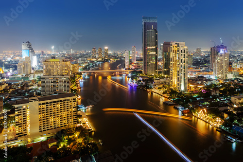 Skycrapper view of Bangkok city with rive at night time.