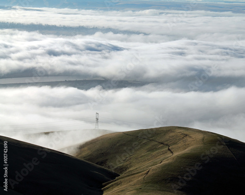 Clouds Covering a Mountain Valley with Rolling Hills photo