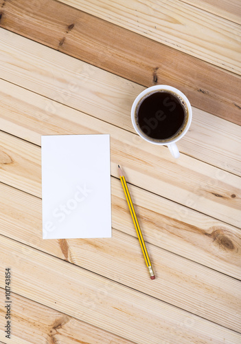 Blank Small Notepad, Cup Of Coffee And Pencil On Wooden Table.