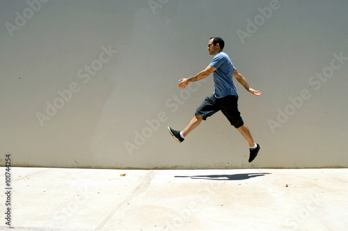Man air walking in front of a wall 