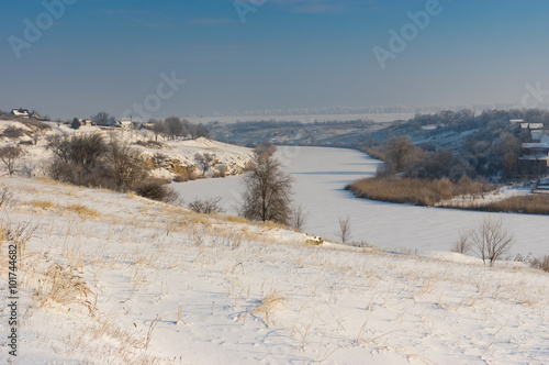 Winter landscape with Small river Sura flowing through Novo-Nikolaevka village in Dnepropetrovskaya oblast, Ukraine