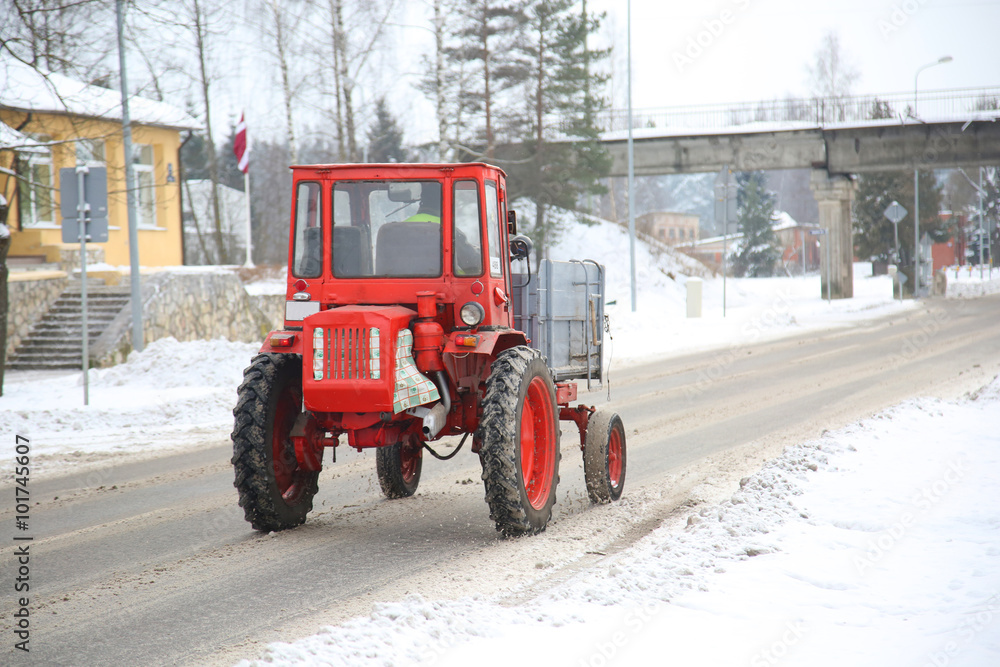 tractor driving down a snow covered road tractor driving down a snow covered road