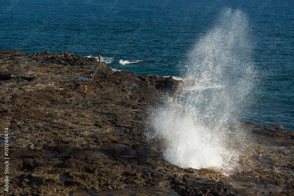 KAUAI, HAWAII, USA-DECEMBER 12, 2014: fishing teenagers at the s
