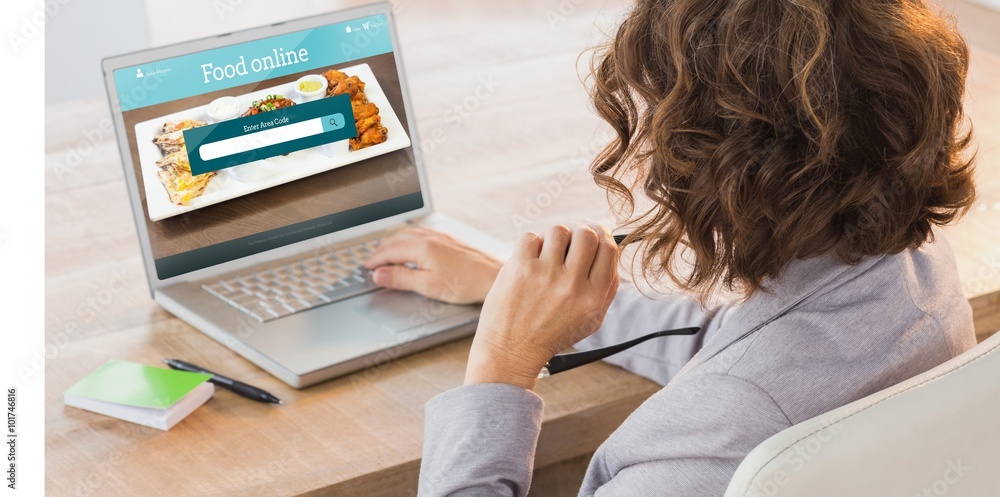 Composite image of businesswoman using laptop at desk Composite image of businesswoman using laptop at desk