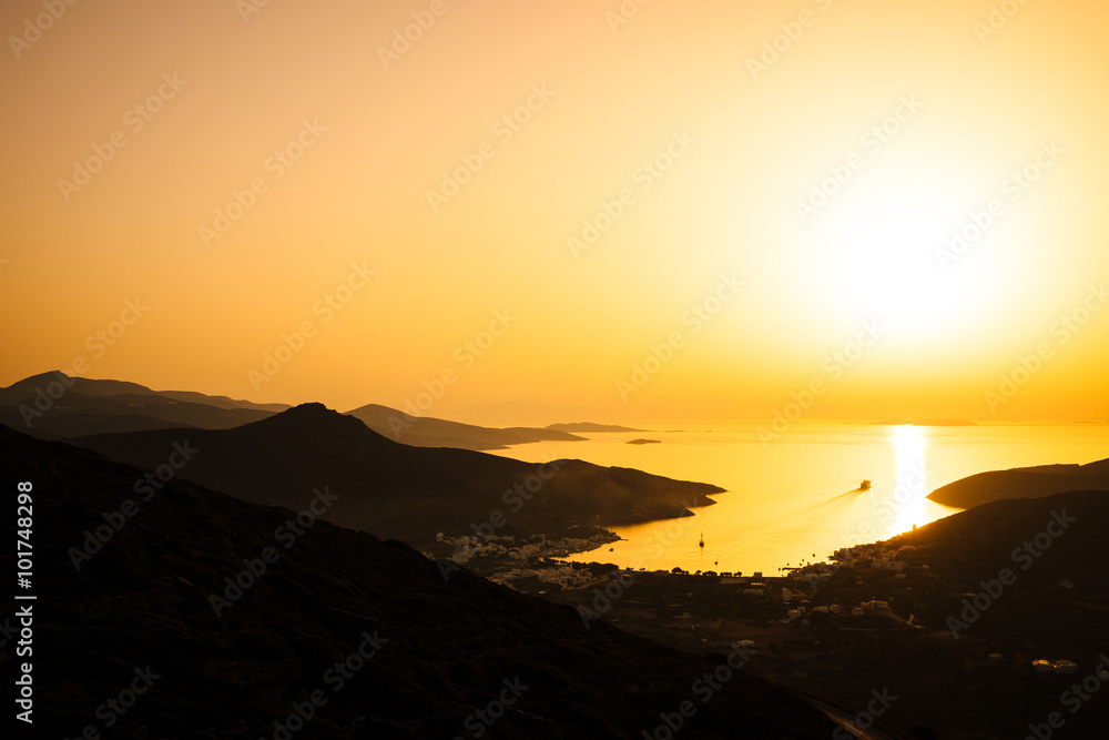 Landscape view of dramatic ocean coastline and port at sunset