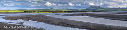 panorama with river banks and white clouds in Iceland