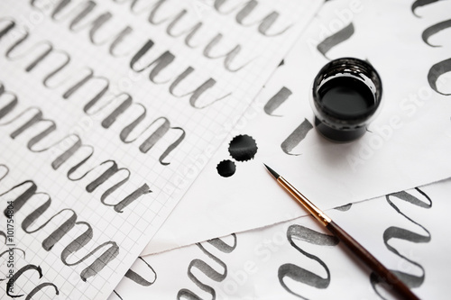 Canvas Print learning calligraphy - paper with example and brush and ink
