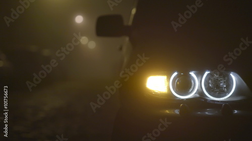 2 in 1 video! The car with a hazard warning light on a dark background. Evening-night time, foggy weather, real time capture