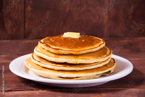 Pancakes with butter on a white plate