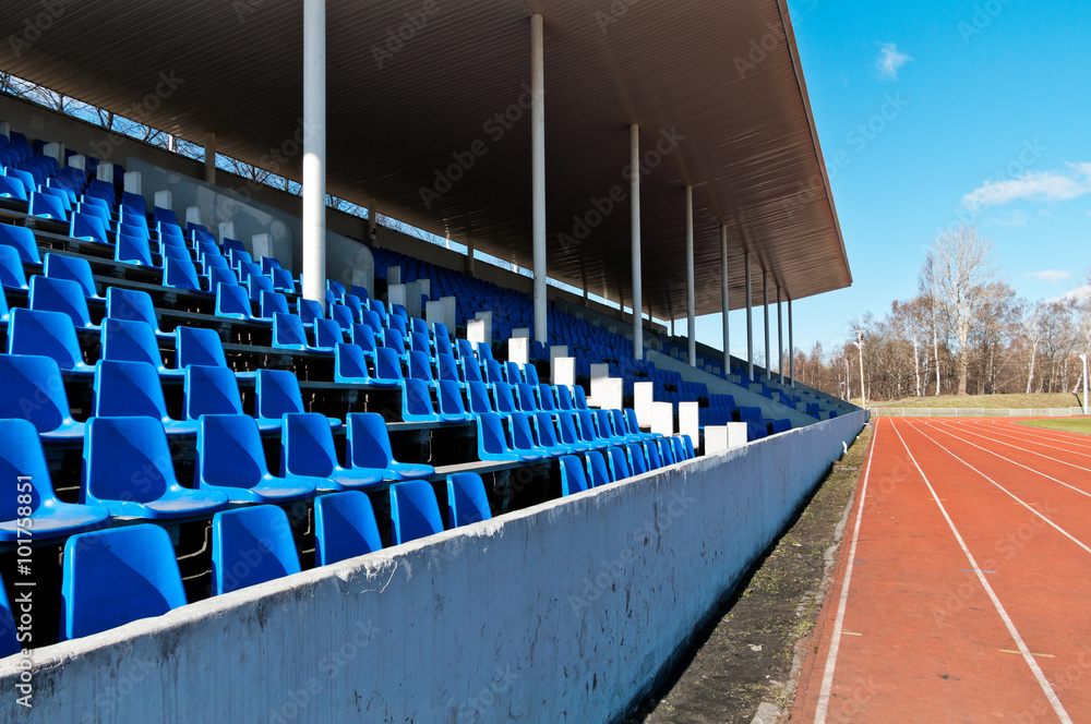 Fototapeta premium tribune of stadium with dark blue seats empty