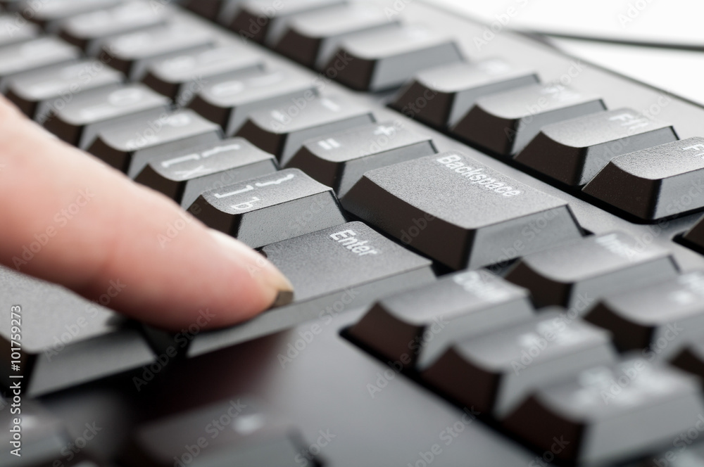 finger women presses a key on the keyboard macro