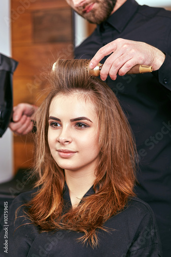 drying, styling women's hair in a beauty salon