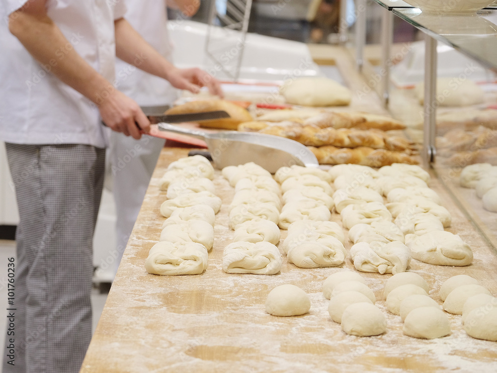 Chefs forming dough in order to prepare bread Chefs forming dough in order to prepare bread