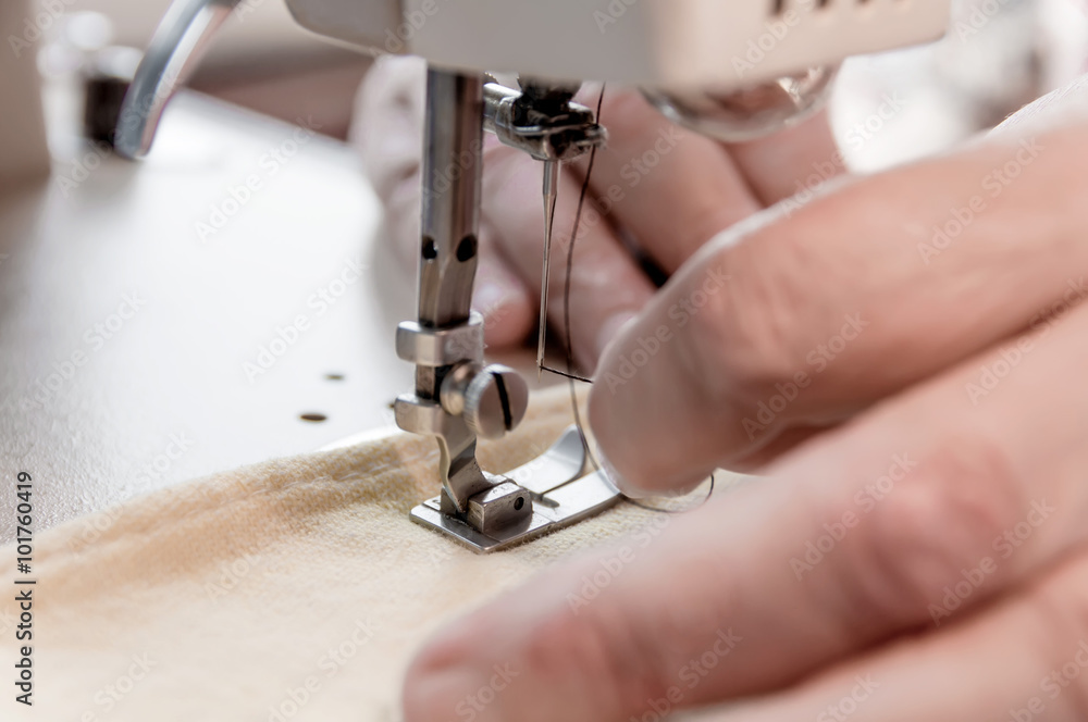 hand of the old woman put to thread a needle sewing machine