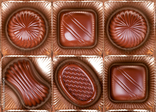 chocolate sweets lie in the cells of the boxes in a number of