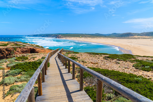 Wooden walkway to Praia do Bordeira beach and beautiful blue sea view  Algarve region  Portugal