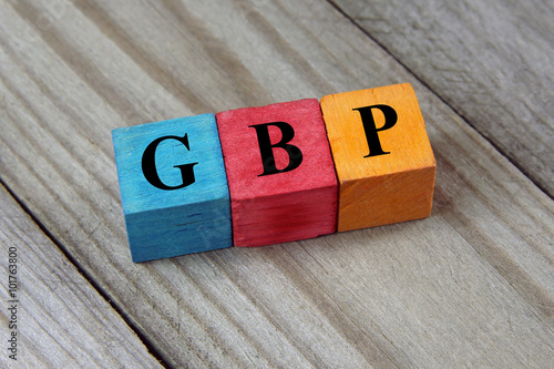 GBP (British Pound) sign on colorful wooden cubes