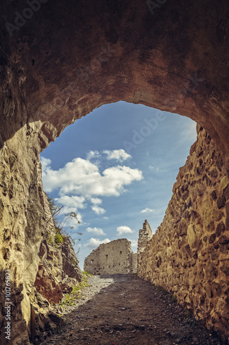 Picturesque view with shady arcade and fortified walls of the medieval Rupea citadel, first attested in 1324, one of the oldest archaeological sites in Romania.