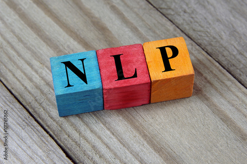 NLP (Neuro Linguistic Programming) sign on colorful wooden cubes photo