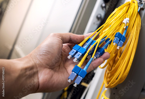 men hand hold fiber optic cable
