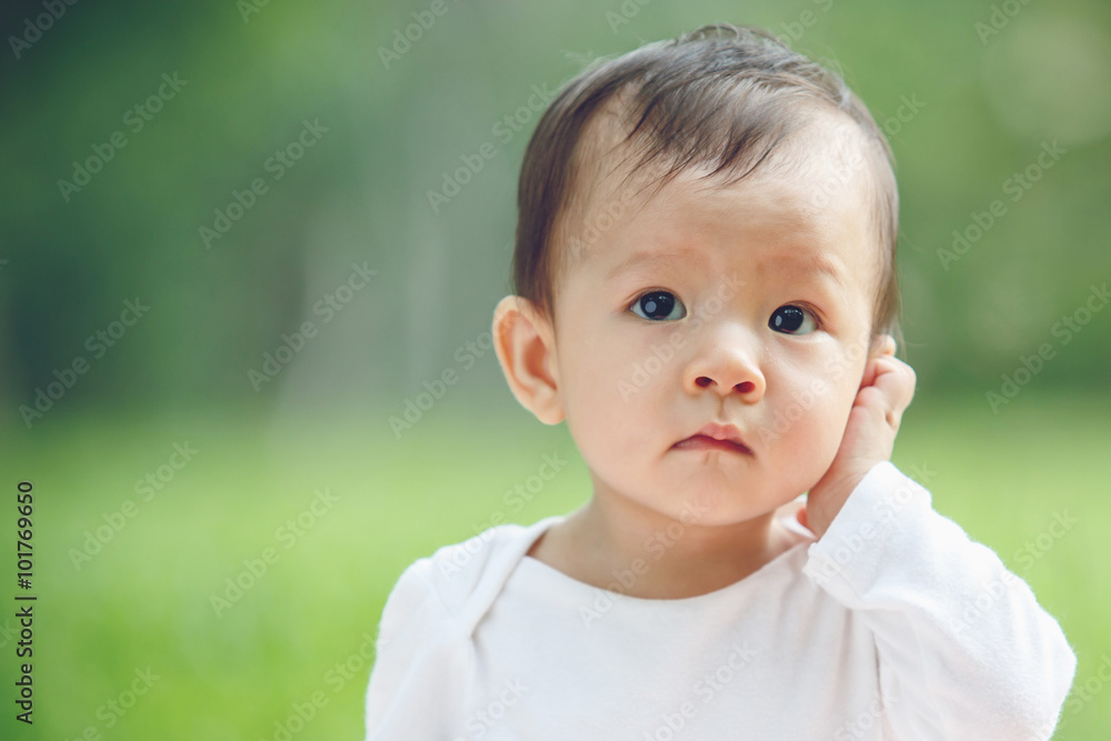 Cute asian baby laughing in garden (soft focus on the eyes) Cute asian baby laughing in garden (soft focus on the eyes)
