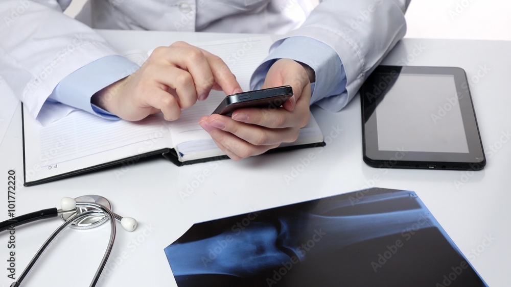 Doctor texting on mobile phone, white Doctor texting on mobile phone, white