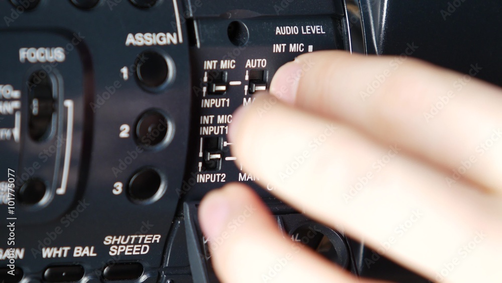 Hand opens audio levels, changes setting of video camera, close up Hand opens audio levels, changes setting of video camera, close up