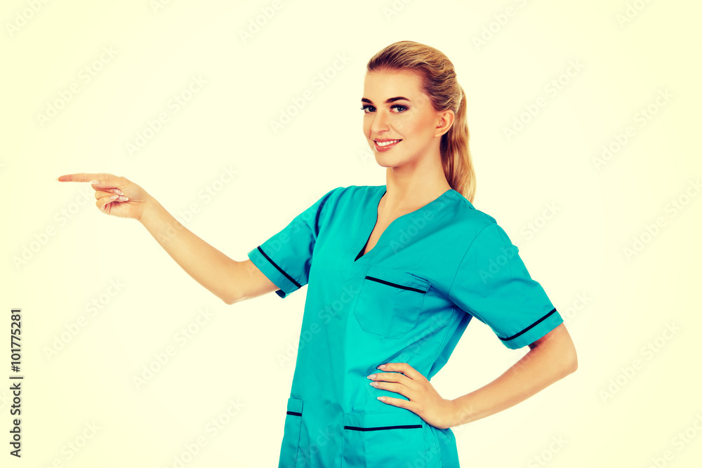 Smiling woman doctor or nurse pointing something Smiling woman doctor or nurse pointing something
