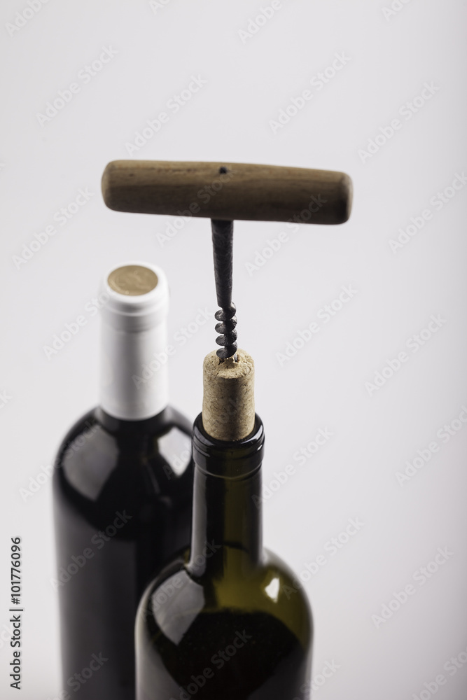 two wine bottles, cork and corkscrew on white background two wine bottles, cork and corkscrew on white background