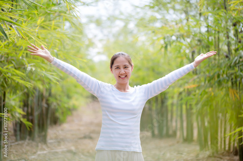 Beautiful Young Asian Woman Enjoying Nature. Healthy Smiling Girl in Green Bamboo Forest.