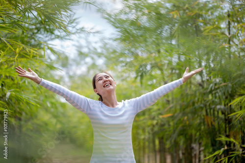 Beautiful Young Asian Woman Enjoying Nature. Healthy Smiling Girl in Green Bamboo Forest.