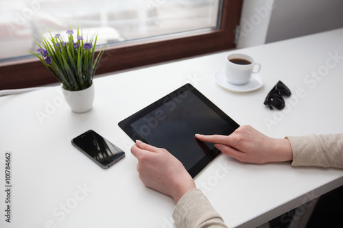 Woman using atablet pc during a coffee break photo