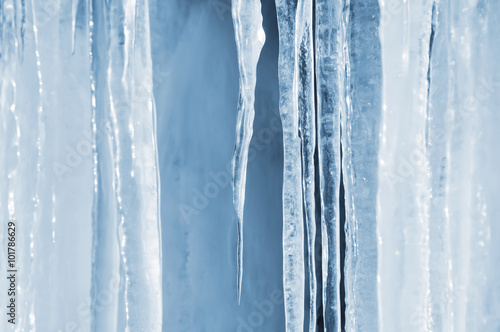 Background of bright transparent icicles in the sunlight