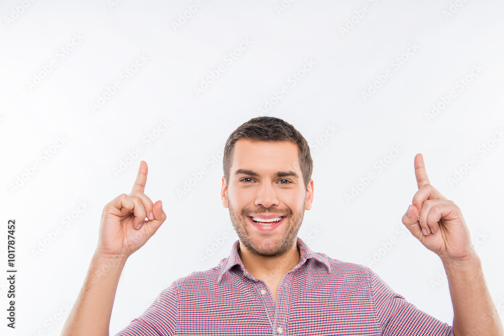 Cheerful young man pointing up Cheerful young man pointing up