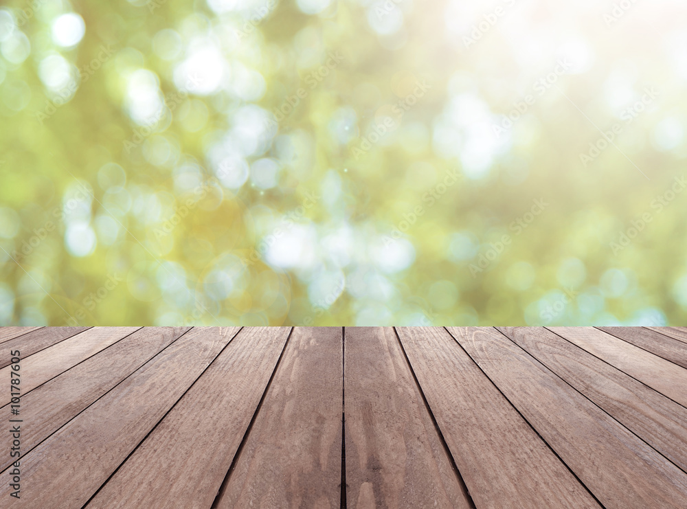 Wooden plank and bright spring bokeh background - can be used for display your products Wooden plank and bright spring bokeh background - can be used for display your products