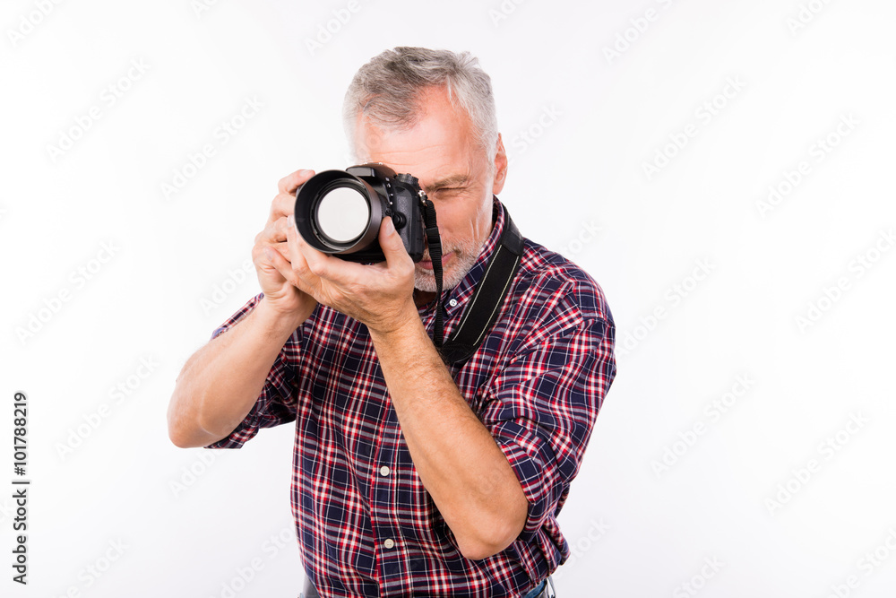 Pretty aged photographer making a photo with camera Pretty aged photographer making a photo with camera