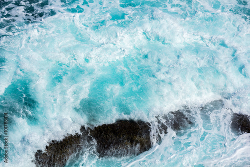 ocean waves crashing on the rocks with white foam