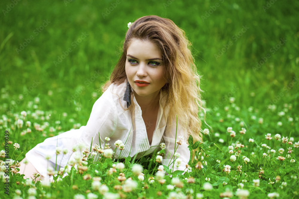 Young blonde woman on green meadow Young blonde woman on green meadow