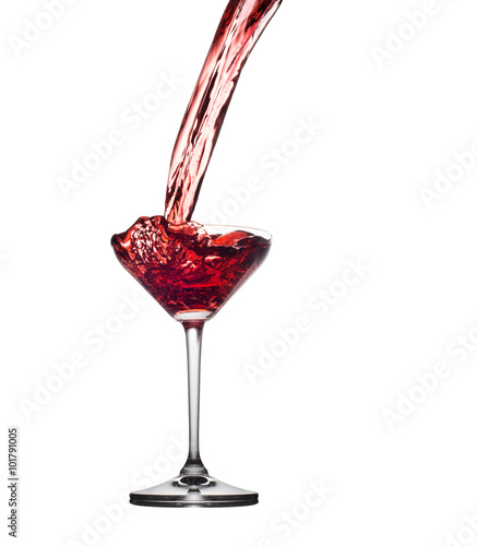 Red cocktail splashing from glass isolated on white background