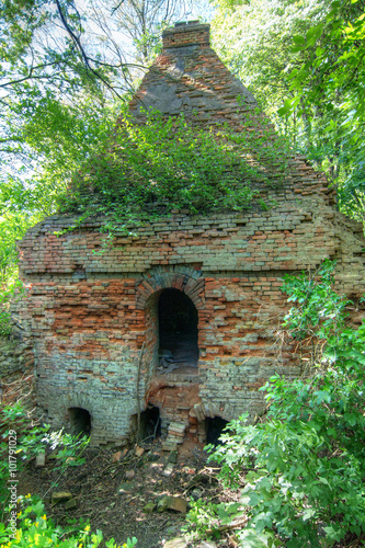 Very old and damaged brick furnace photo