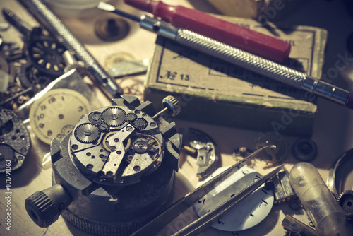 Old Watchmaker Studio. A watch makers work top. The inside workings of a vintage mechanical watch. photo